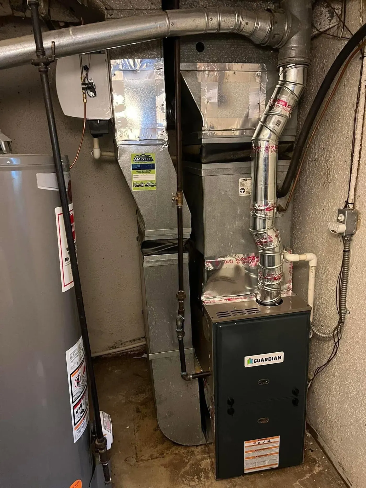 New Guardian gas furnace installed in a basement with sealed sheet-metal plenum and new flue