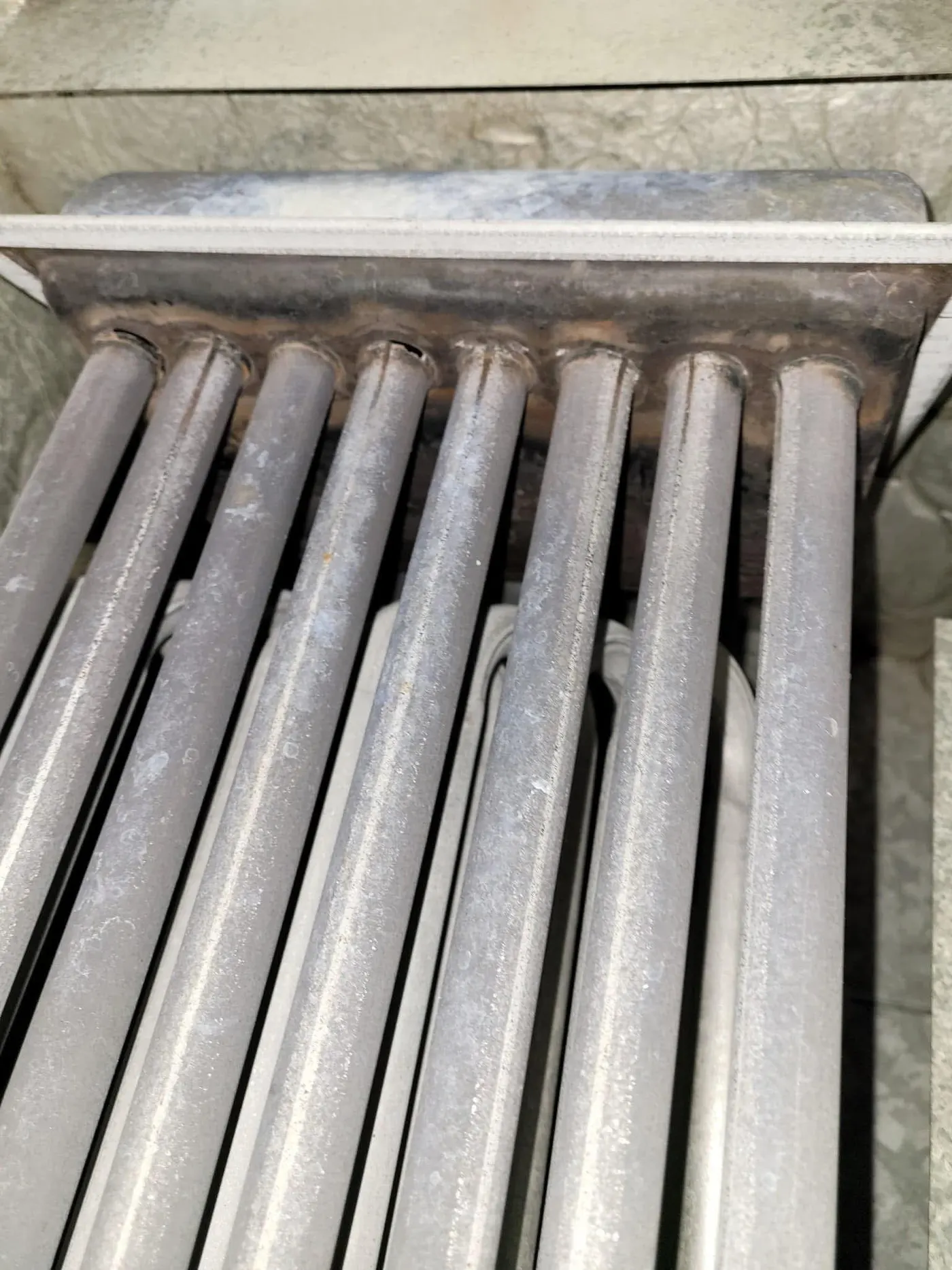 Close-up of furnace heat exchanger tubes during an inspection
